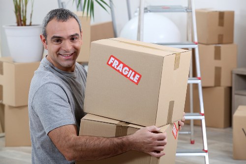 Moving team loading furniture safely with protective equipment