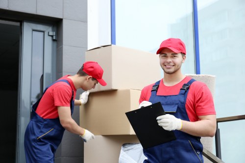 Trained removals staff carrying boxes through an Aldwych property